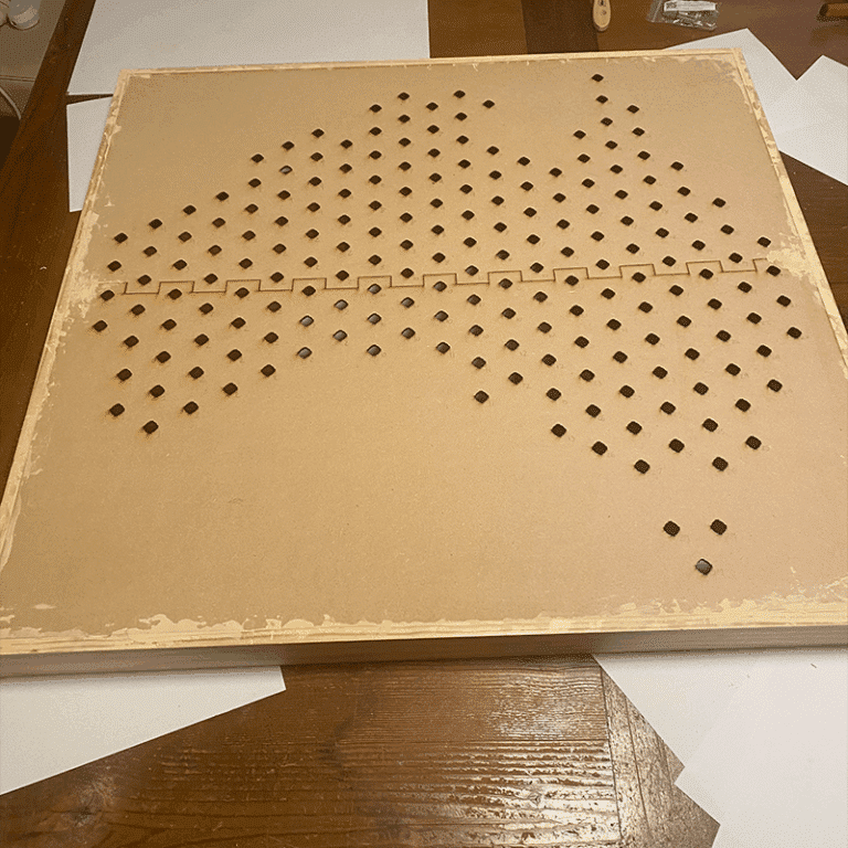 Image of unfinished wood frame and laser cut MDF panels.