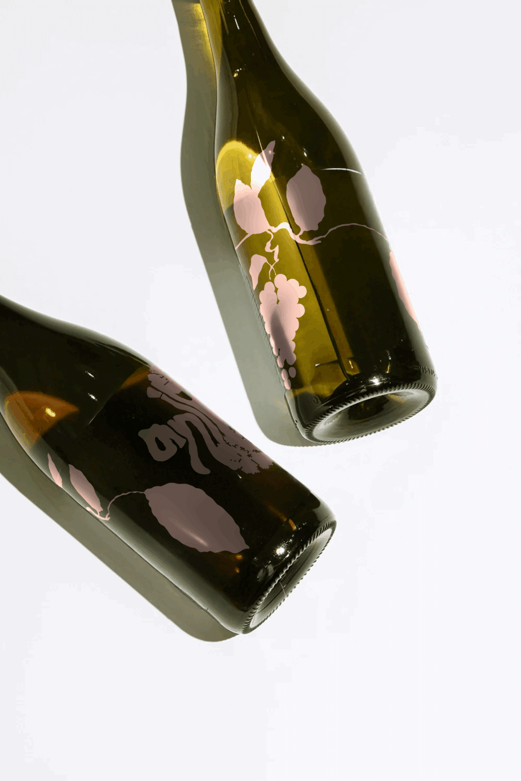 Anika Estate wine bottles featuring minimalist pink illustrations of grapevines and leaves, photographed on a light background. The design highlights the organic, contemporary branding of Anika Estate, reflecting a balance between contemporary design and natural inspiration.
