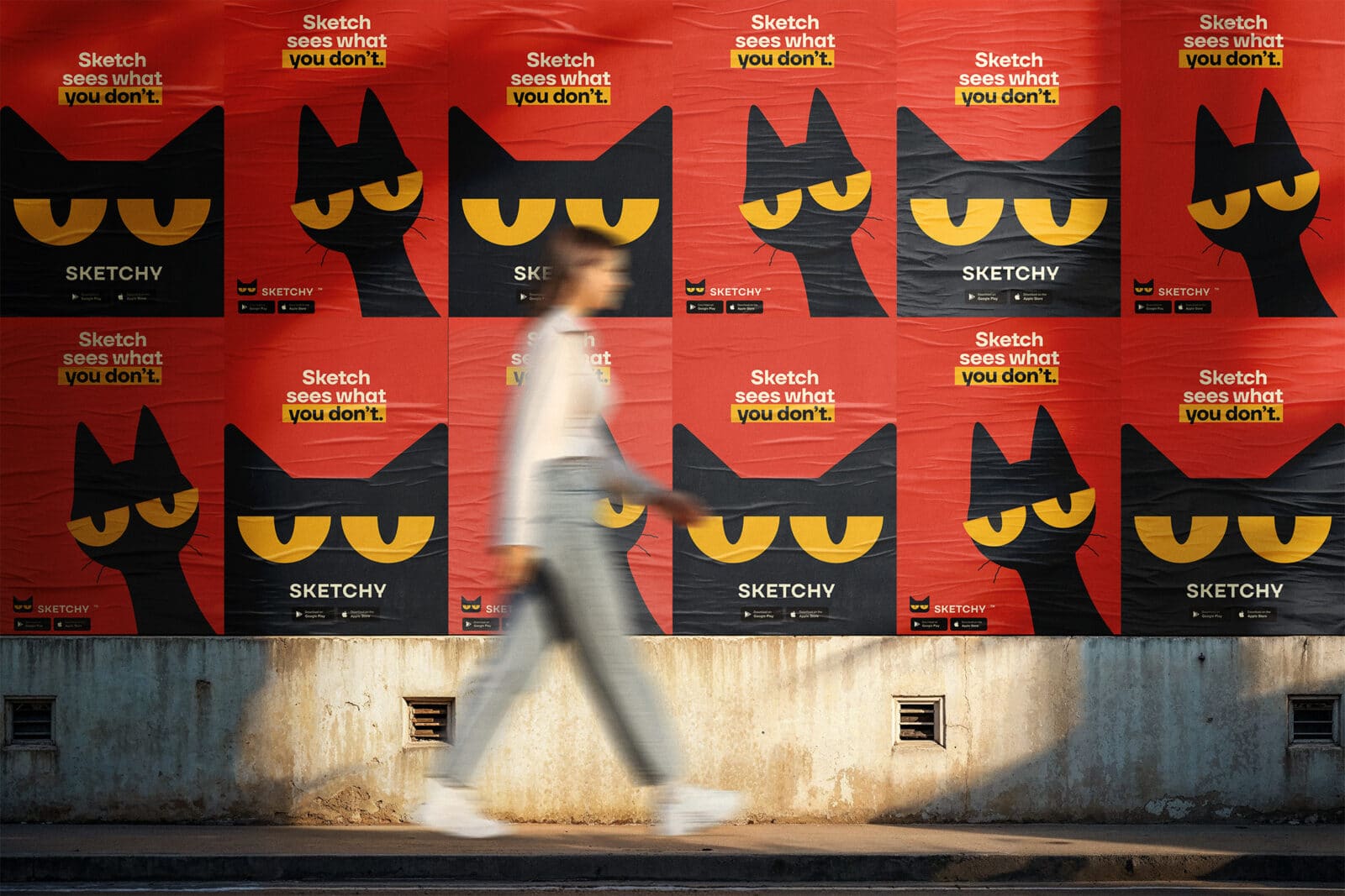 A blurred person walks past a wall covered in bright red Sketchy posters. Each poster features the brand’s black cat with yellow eyes and the tagline “Sketch sees what you don’t.” The design alternates between front-facing and side-profile cat illustrations, creating a striking pattern. The bold yellow and black typography stands out against the red background, while the Sketchy logo and app store icons appear along the bottom of each poster.